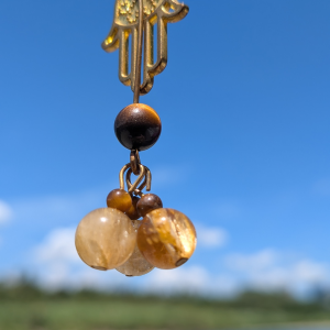 Golden Hamsa Hand Abundance Necklace with Rutilated Quartz, on an adjustable black cord