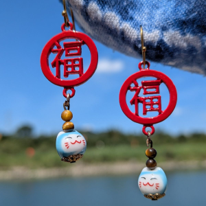Hook earrings featuring red fortune piece that reads 福, with Tiger's Eye beads and small blue Maneki Neko lucky cats below